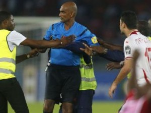 Mr Rajin Draparsad Seechum being Protected by a security official during the controversial match between Tunisia and host of the 2015 African Cup of Nations (AFCON) - Equatorial Guinea.