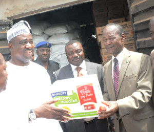 L-R: Governor of Benue State, Dr. Gabriel Suswam receives a Noodle pack from the Special Adviser to the President of Dangote Group, Eng. Joseph Makoju while Head, Dangote's special Duties, Gboko Plant, Dr. Bem Mellad looks on.