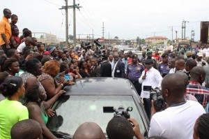 Delta State Governor, Dr. Emmanuel Uduaghan (holding microphone) interacting with market men and women during his inspection of the on-going clean-up at Refinery Road , Warri, Thursday.