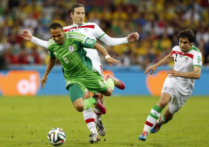 Peter Odemwingie of Nigeria L in action against Khosro Heydari R and Andranik Timotian of Iran C during the FIFA World Cup 2014 group F preliminary round match between Iran and Nigeria