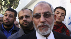 Mohamed Badie, the leader of the Muslim Brotherhood, queues outside a polling centre to vote in the final stage of a referendum on Egypt's new constitution in Bani Sweif