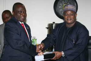 New Group Managing Director of the NNPC Dr. Joseph Dawha receiving the hand over notes from former  GMD Engr. Andrew Yakubu at the NNPC Towers Abuja