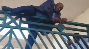 Hon. Kawu Suleiman, deputy minority leader Scales the fence of the National Assembly.