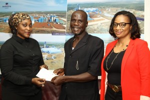 REWARD WELL DESERVED: Adamu Nahuta,(middle), receiving a cheque of N500,000.00 from Maijidda Modibbo (left) of Corporate Communication, Dangote Group and Nike Sanmi Adebayo (right) Customer Care, Dangote Cement for helping to arrest a Dangote truck driver involved in illegal haulage in the on-going campaign by the Group against the use of its truck for illegal haulage.